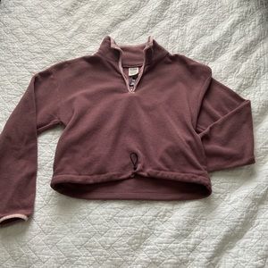 A pink cropped sweater